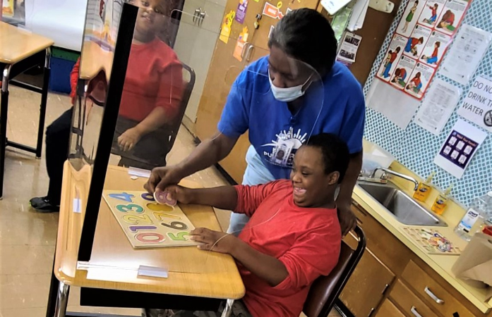  Teacher helping a student with lesson